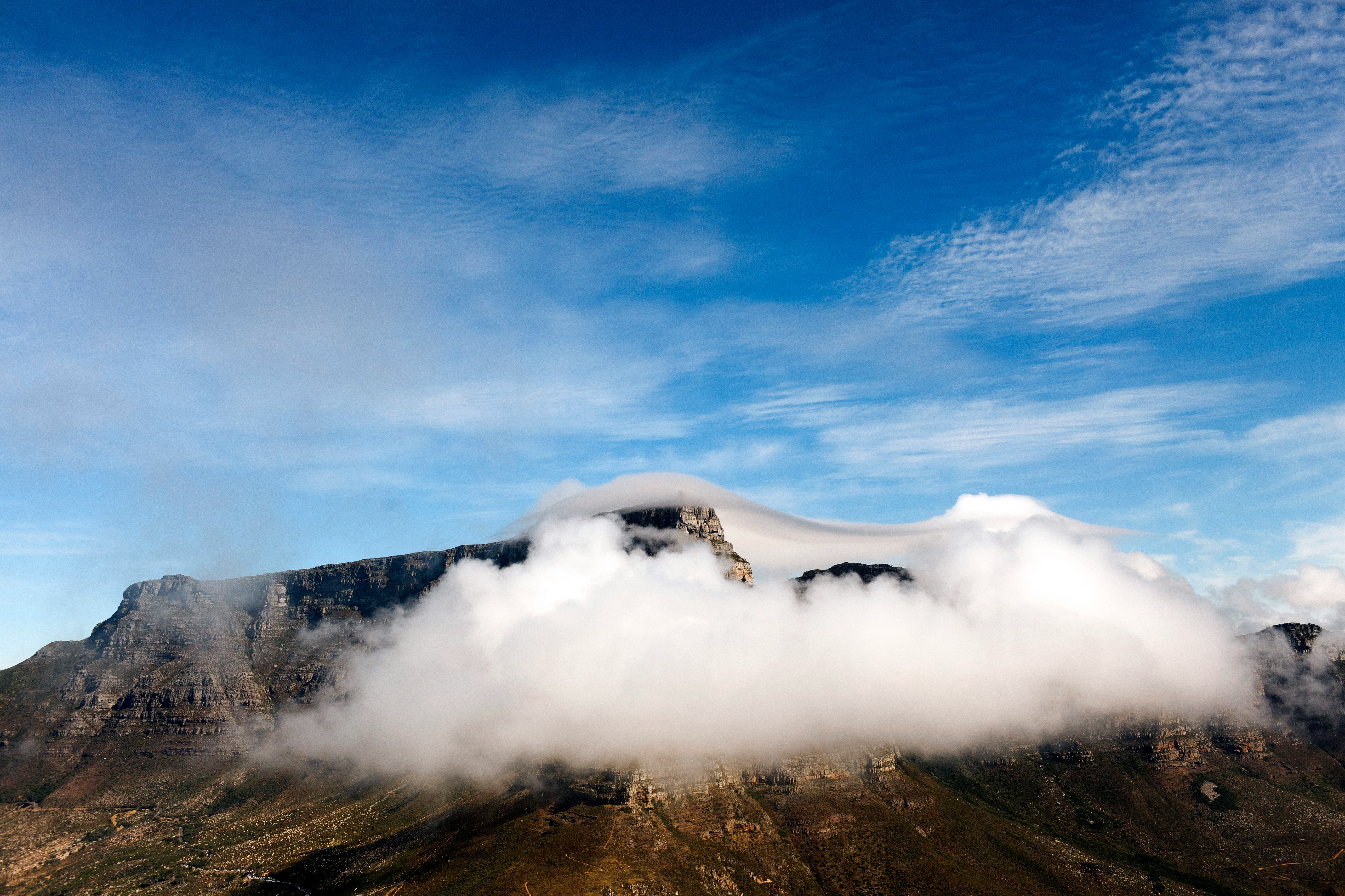 mountain covered in white clouds